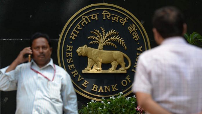 An Indian man speaks on the phone outside the Reserve Bank of India (RBI) head office in Mumbai on April 5, 2018. India's central bank on April 5 kept interest rates at a seven-year-low despite a slowdown in inflation and a recent spurt in economic growth. The Reserve Bank of India (RBI) said the benchmark repo rate -- the level at which it lends to commercial banks --- would remain unchanged at 6.0 percent. / AFP PHOTO / PUNIT PARANJPE (Photo credit should read PUNIT PARANJPE/AFP/Getty Images)