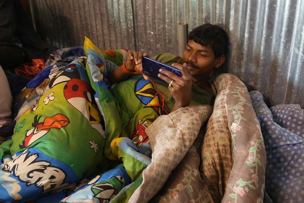 A worker part of rescue ops using his phone after finishing his shift | Suraj Singh Bisht | ThePrint