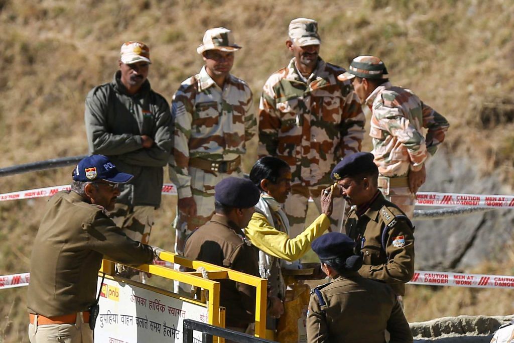 A priest applies ‘tilak’ on forehead of police personnel part of rescue ops | Suraj Singh Bisht | ThePrint
